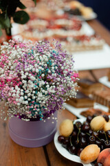 A bouquet of flowers in a round box on a festive table.