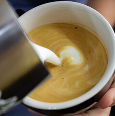 pouring milk into a cup