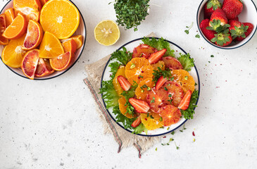 Raw Homemade Citrus Salad with strawberries and sprouts. Healthy natural organic food. Concept of low calories delicious desserts.