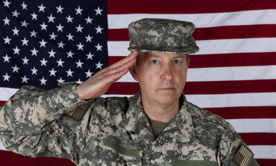 Man saluting while wearing military outer shirt plus cap with US flag in background