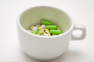 green pills in a cup, 