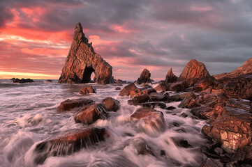 Seascape in the Campiecho beach on a powerfull sunset in Muros de Nalon, Asturias