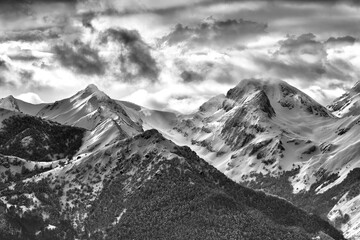 Black and white spectacular landscape of mountain range covered with snow in cold winter