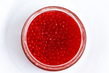 red salted salmon caviar in a jar on a white background