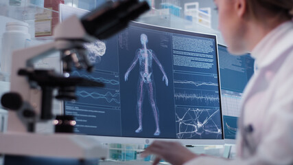 Female doctor working in laboratory. Studying human skeleton and DNA samples