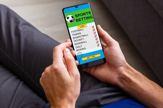 Businessman using smartphone against gambling app screen