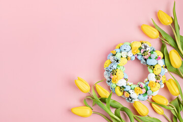 Handmade diy home interior decoration wreath with colorful easter eggs and tulips