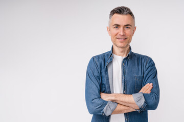 Confident caucasian middle-aged man in casual clothes with his arms crossed isolated over white background - Powered by Adobe
