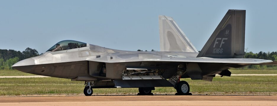 An Air Force F-22 Raptor fighter jet taxiing on a runway.