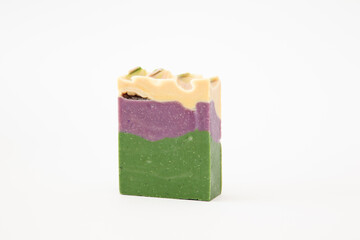 Multicolored three-layer handmade soap on a white background. Skin care product