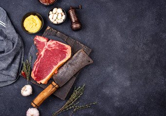 Raw uncooked T-bone steak with spices