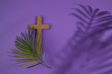Palm sunday background. Cross and palm on purple background.