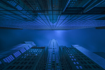 From below exterior of modern high rise buildings with glass mirrored walls under dark blue sky on street of Chicago in USA