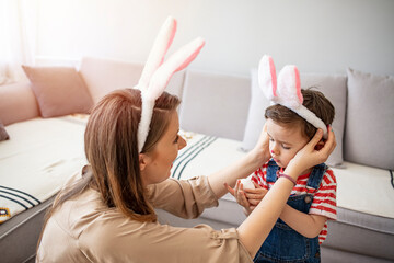 Happy easter! A mother and her son painting Easter eggs. Happy family preparing for Easter. Cute...
