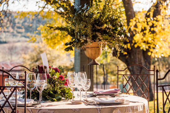 General level of transparent glass vases with bunches of fresh flowers placed on table for event