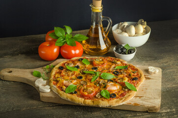 Delicious fresh homemade pizza with ham on wooden background with selective focus
