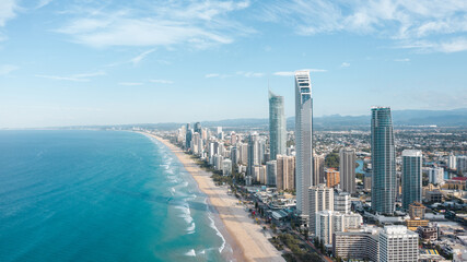 Breathtaking aerial view of modern skyscrapers located near famous sandy Surfers Paradise Beach washing by powerful ocean in Queensland