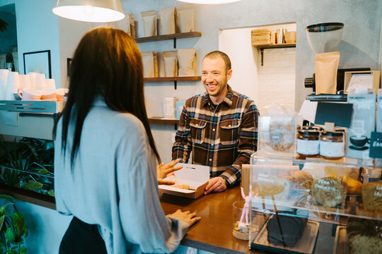 Woman buying takeaway coffee in a coffee shop