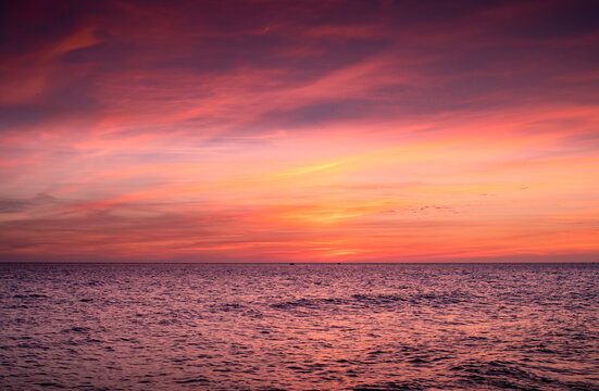 Breathtaking view of vibrant sundown sky over wavy sea in evening in Cadiz