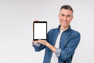 Happy caucasian middle-aged man showing tablet`s screen isolated over white background