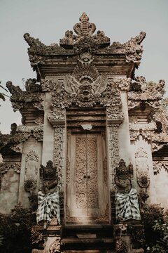 Low angle exterior of entrance of historical hindu Ubud Palace or Puri Saren Agung with traditional statues located in Bali in Indonesia