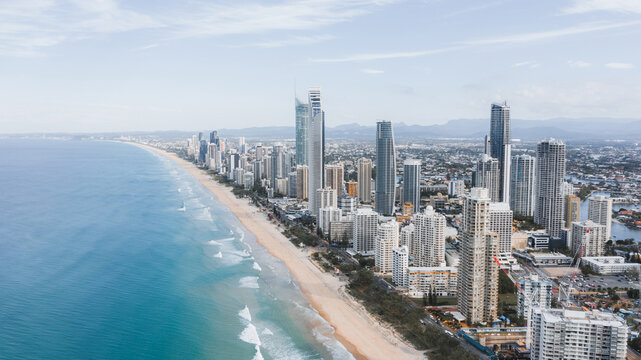 Breathtaking aerial view of modern skyscrapers located near famous sandy Surfers Paradise Beach washing by powerful ocean in Queensland