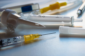 Syringes or injections for vaccines and an oxygen tube.