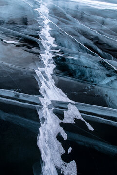 Top view ice abstract pattern of frozen Lake Baikal on cloudy winter day