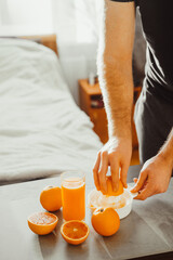 Close up of person making fresh orange juice at home