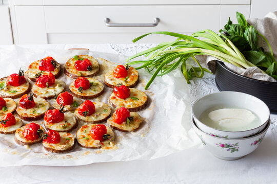 From above of yummy appetizers with fresh eggplants mozzarella whole cherry tomatoes olive oil and onion