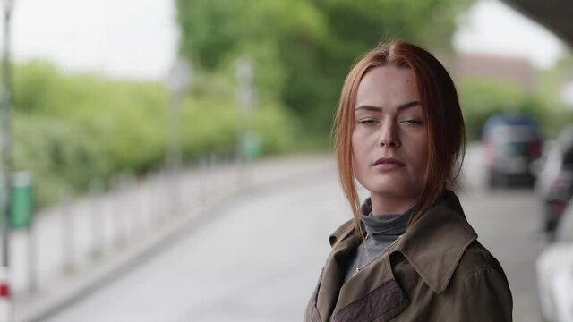 [4k] arrogant woman looking at camera with her nose up in the air in urban street