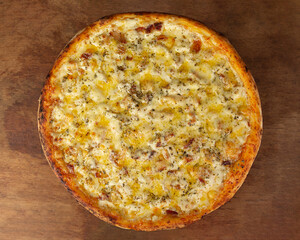 Top view of isolated pizza with breast chicken and cream cheese, on wooden board 