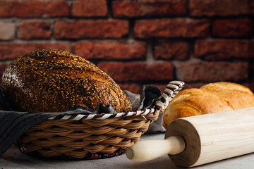 Delicious wholegrain bread in straw basket on table