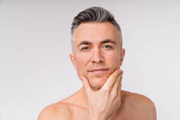 Sexy caucasian man looking into a camera shirtless isolated over white background