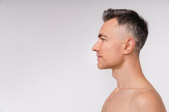 Side view shot of an attractive mature naked man isolated over white background