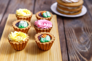 Shortbread and sponge cake and cream cake decorated with small flowers and a cup of tea.