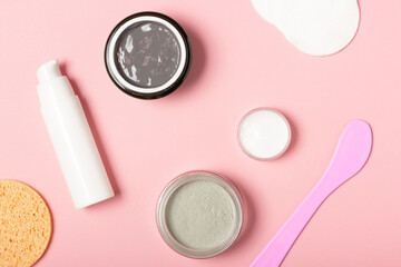 Cosmetic jar with cream or cosmetic face mask and accessories. A purifying and moisturizing clay mask. Top view, flat lay