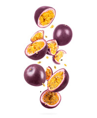 Whole and sliced ripe passion fruit in the air, isolated on a white background - obrazy, fototapety, plakaty