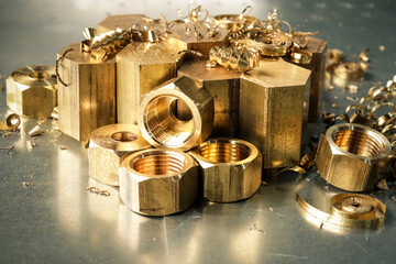 Hexagonal bars and brass products made on CNC metalworking machines. Manufacturing of parts from brass. Close-up. 