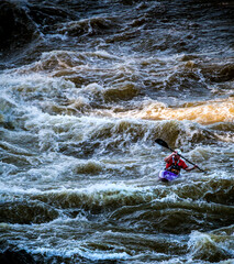 A kayaker navigating the rapids of Potomac River in Great Falls National park in Virginia and Maryland.