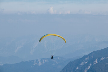 experienced man parachutes around the Austrian Alps and tries to use the right air currents to get to the right place. Dangerous sports experience. Feel the freedom