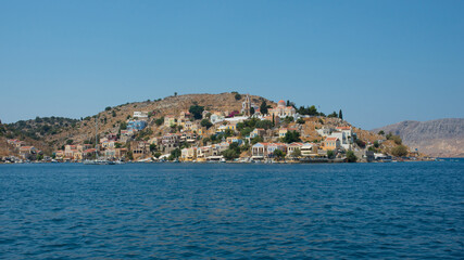 Fototapeta premium Beautiful view from the water of colorful Symi island in summer. Dodecanese, Greece