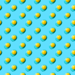 Food pattern with yolks on blue background. Easter background.