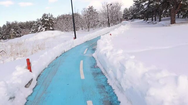 Bicycle lane in park in winter.
Exercising during the winter and enjoying the scenery and the snow covered forest.
Here we have a nice fresh bicycle lane in Erzurum, Turkey.
nearby frozen forest