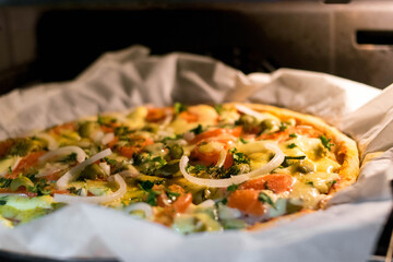 Homemade pizza. Pizza in the oven. Family evening. Homemade baking. Bake. Pizza. Leisure at home. Cooking. Recipes.