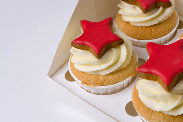 cupcakes with cream and red stars on a white background
