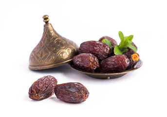 HURMA, Dates. Dried dates fruit with bronze bowls on white background. Popular fruit of Ramadan. - obrazy, fototapety, plakaty