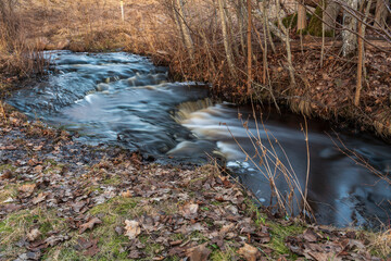 waterfall in several stages and fallen leaves