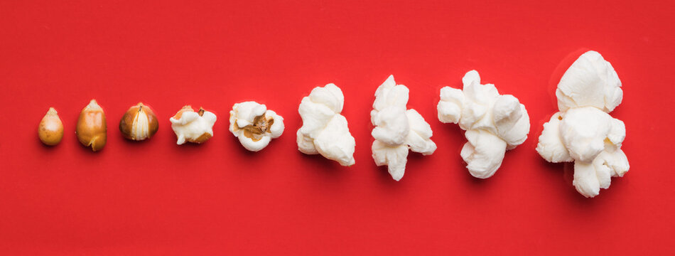 Closeup of some popcorn on a red background - Powered by Adobe