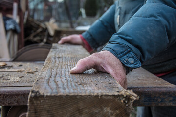 Carpenter's Hands Cutting Wood With Tablesaw